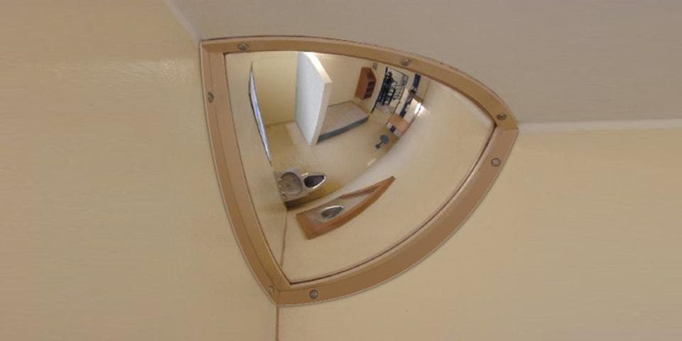Quarter dome mirror installed at a wall and ceiling corner